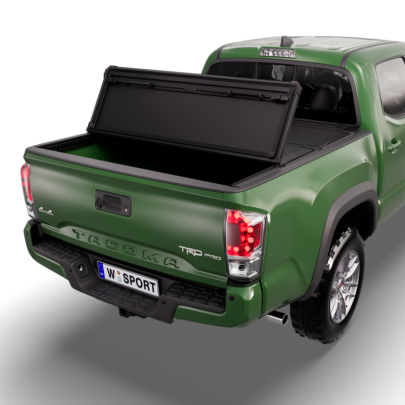 Worksport NEXUS hard folding tonneau cover on a pickup: studio render of a green third-generation Toyota Tacoma TRD Pro from the rear quarter with a black NEXUS hard folding tonneau cover with the rear panel folded forward