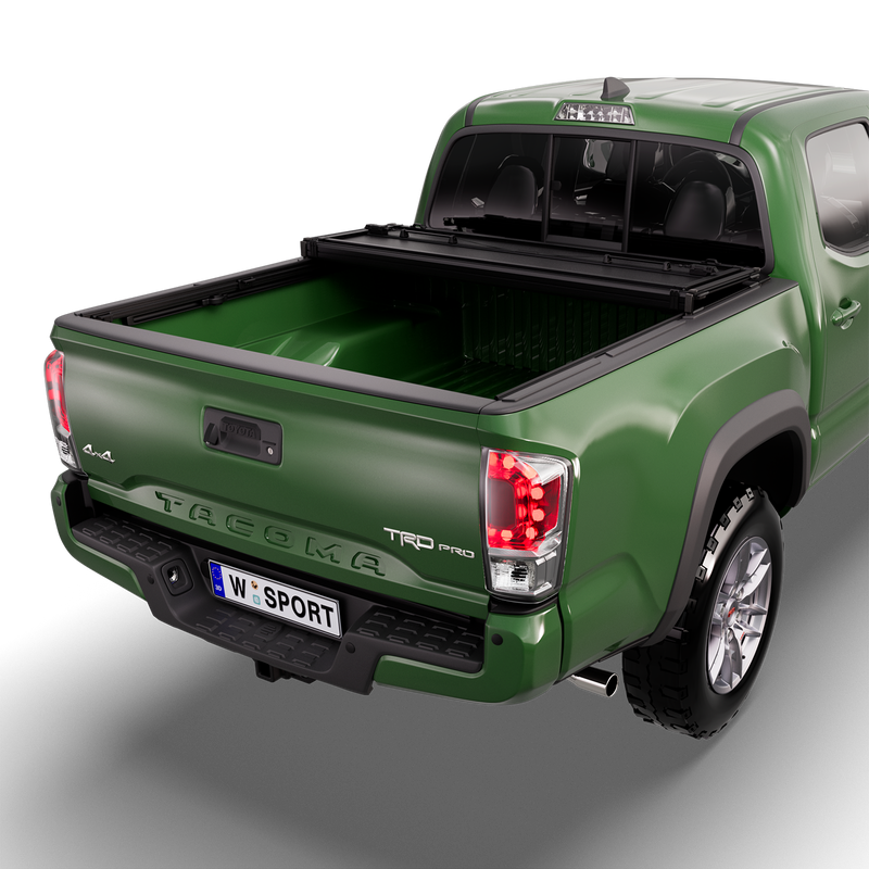 Worksport NEXUS hard folding tonneau cover on a pickup: studio render of a green third-generation Toyota Tacoma TRD Pro from the rear quarter with a black NEXUS hard folding tonneau cover folded twice and stacked at the cab