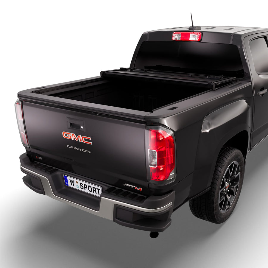 Worksport NEXUS hard folding tonneau cover with its panels partly folded toward the cab