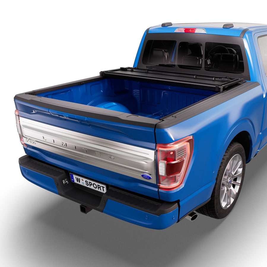 Worksport NEXUS hard folding tonneau cover with its panels partly folded toward the cab