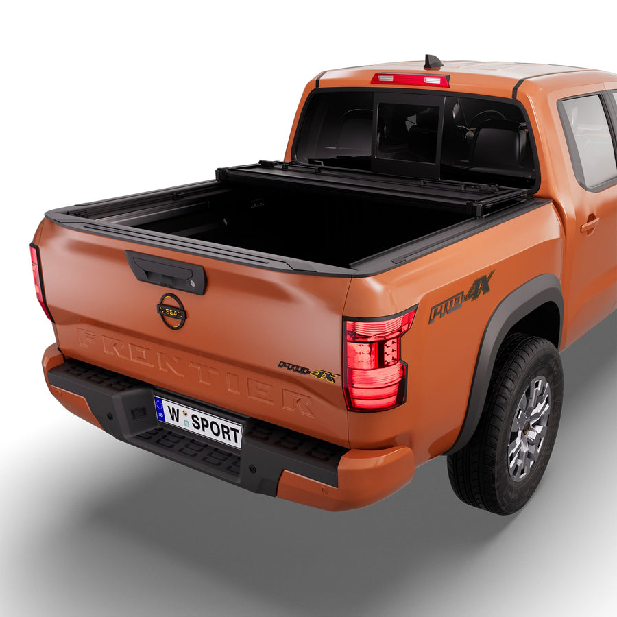 Worksport NEXUS hard folding tonneau cover with its panels partly folded toward the cab