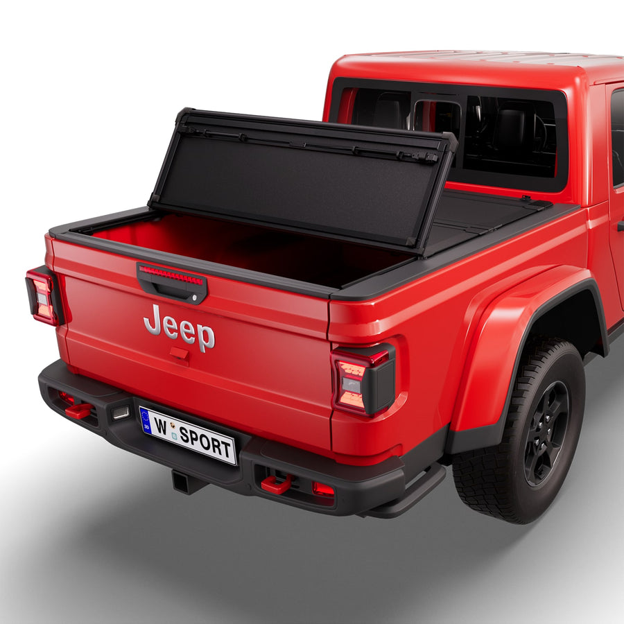 Worksport NEXUS hard folding tonneau cover with its panels partly folded toward the cab