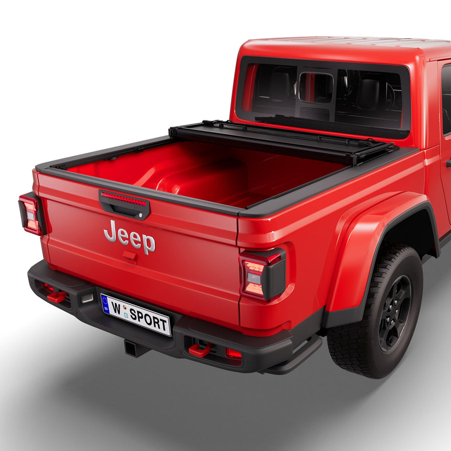 Worksport NEXUS hard folding tonneau cover with its panels partly folded toward the cab