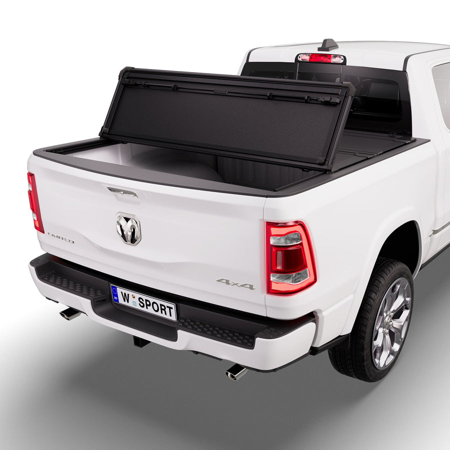 Worksport NEXUS hard folding tonneau cover with its panels partly folded toward the cab
