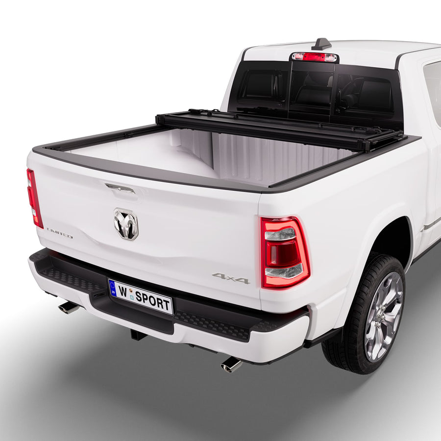 Worksport NEXUS hard folding tonneau cover with its panels partly folded toward the cab