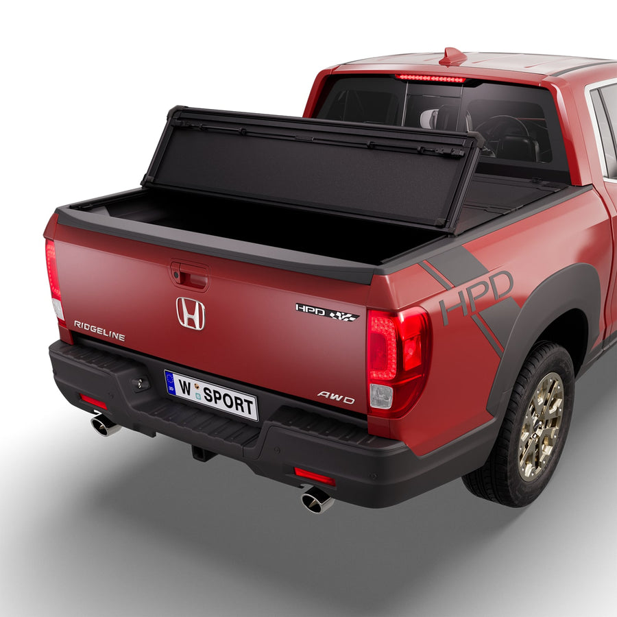 Worksport NEXUS hard folding tonneau cover with its panels partly folded toward the cab