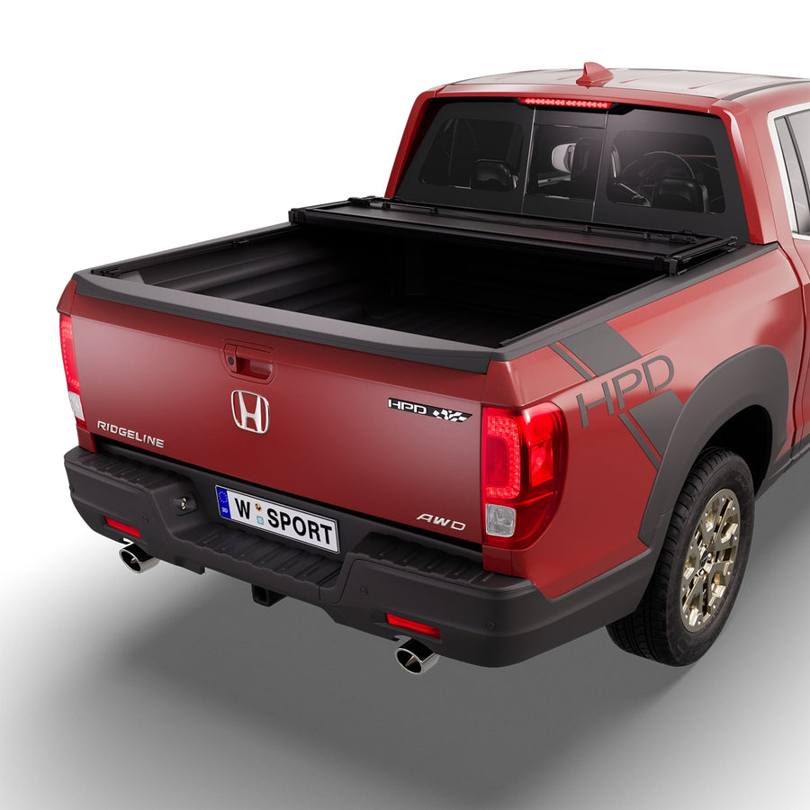 Worksport NEXUS hard folding tonneau cover with its panels partly folded toward the cab