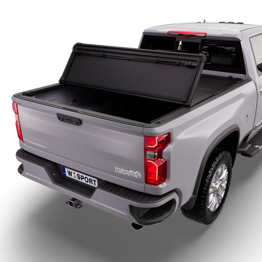 Worksport NEXUS hard folding tonneau cover with its panels partly folded toward the cab