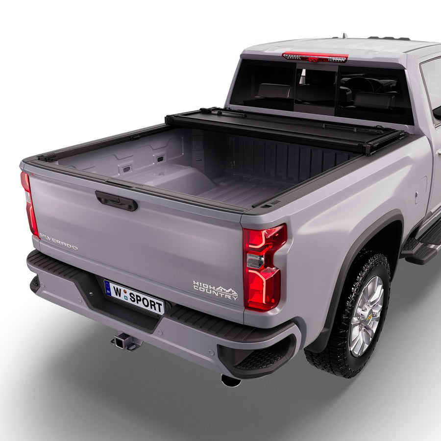 Worksport NEXUS hard folding tonneau cover with its panels partly folded toward the cab