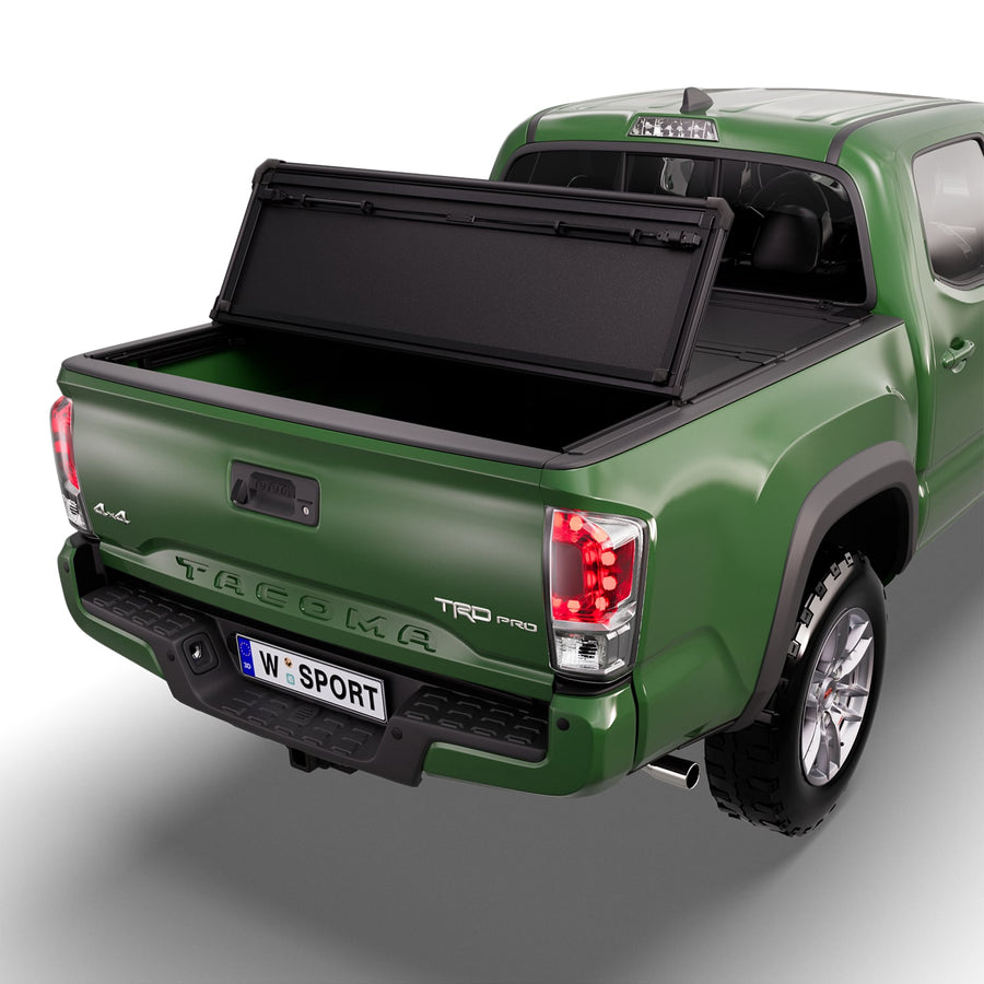 Worksport NEXUS hard folding tonneau cover with its panels partly folded toward the cab