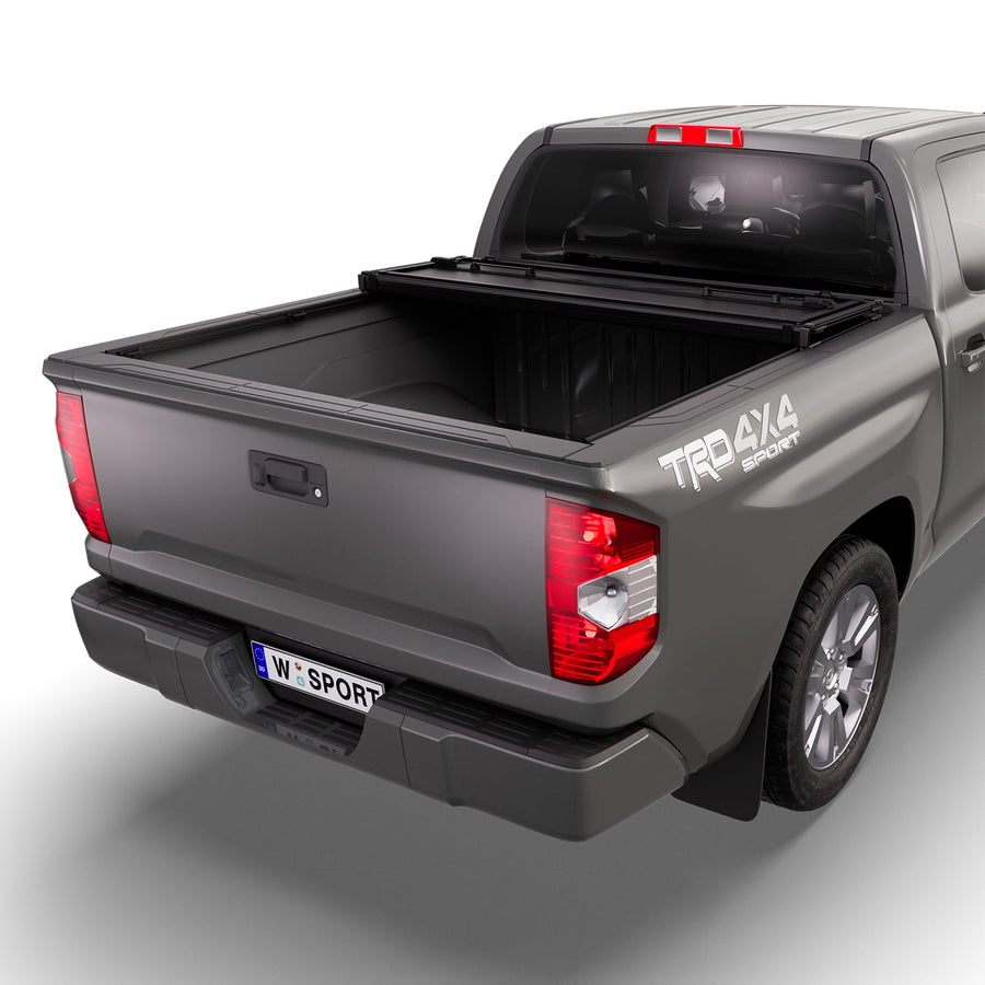 Worksport NEXUS hard folding tonneau cover with its panels partly folded toward the cab